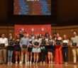 A group of NCC student athletes stands onstage, holding their awards, at the third annual Chippy's awards ceremony.