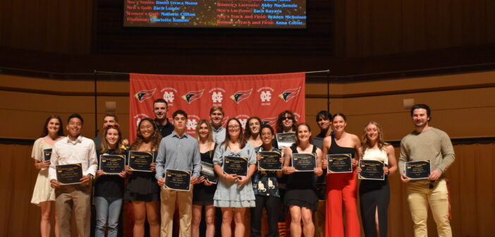 A group of NCC student athletes stands onstage, holding their awards, at the third annual Chippy's awards ceremony.