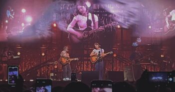 Gracie Abrams on stage with her guitar