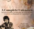 An image of Bob Dylan playing guitar is displayed over a cream background. The skyline of New York City is above the movie title "A Complete Unknown."